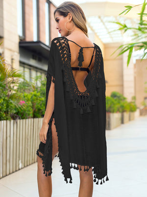 Black crochet back tassel trim cover-up with side slits and fringed hem.