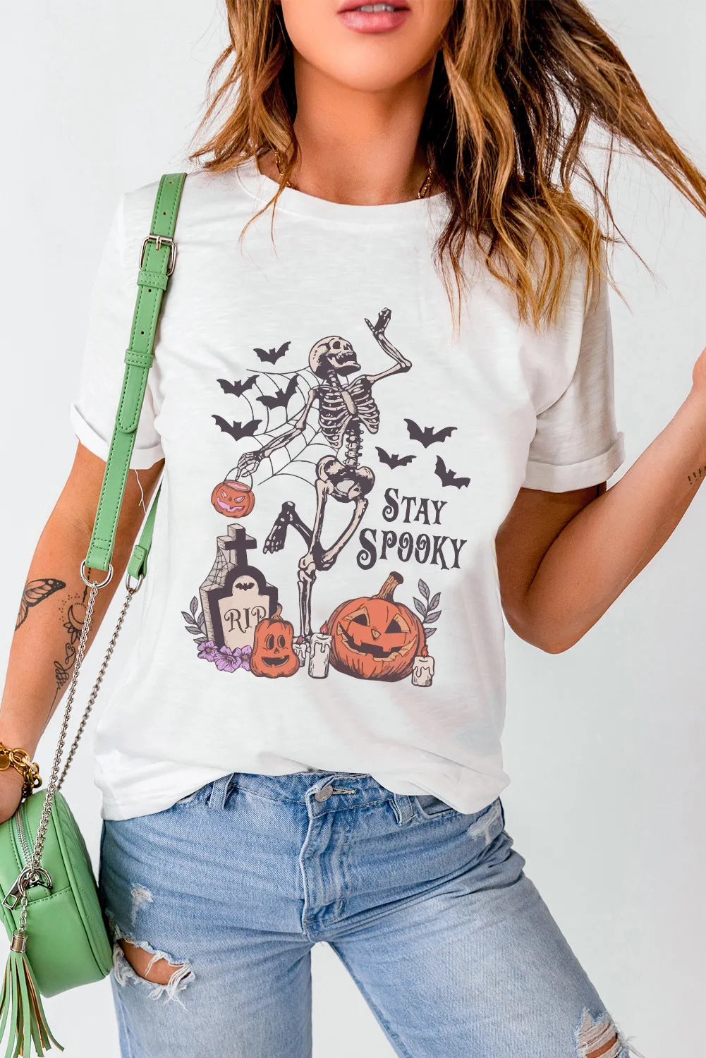 White graphic t-shirt with skeleton, pumpkins, bats and Stay Spooky text