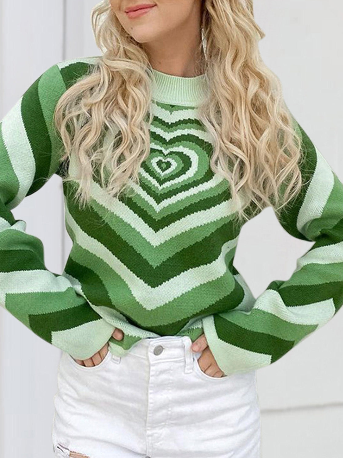 Light green knit sweater with mock neck and heart stripe pattern.
