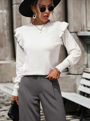 White crew neck sweater with contrast trim ruffle shoulders and long sleeves.