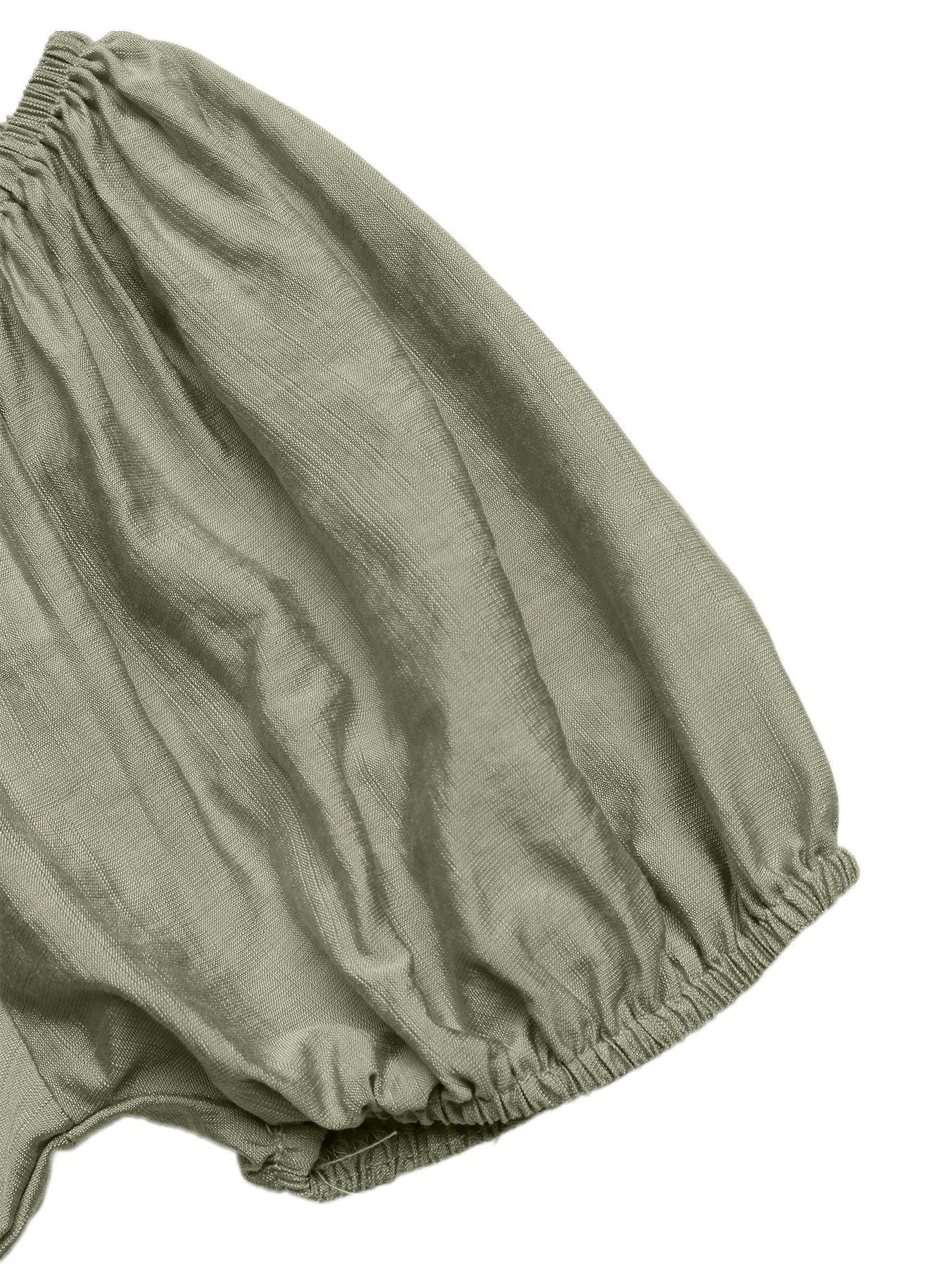 Sage green smocked waist maxi dress detail with textured fabric and elasticated hem.