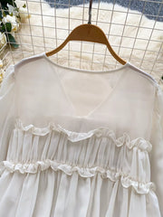 White chiffon blouse with ruffled V-neck and tie-front detail.