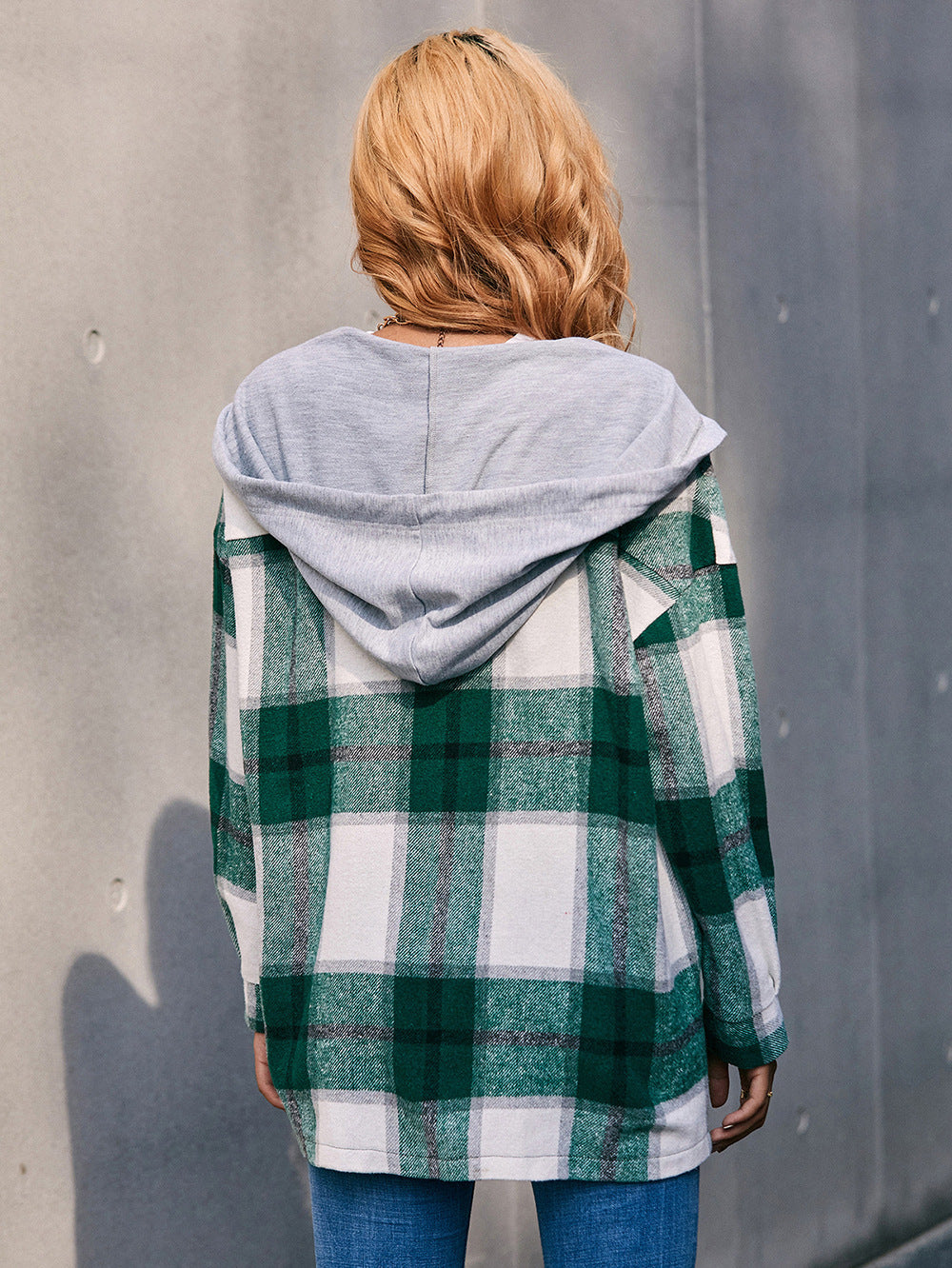 Oversized green plaid shacket with grey hood and long sleeves.