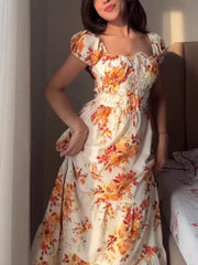 Floral tie-detail ruched waist dress with puff sleeves and square neckline.