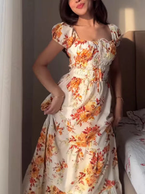 Floral tie-detail ruched waist dress with puff sleeves and square neckline.