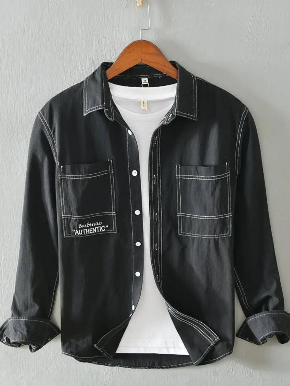 Black men's casual shirt with contrast stitching and two chest pockets.