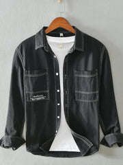 Black men's casual shirt with contrast stitching and two chest pockets.