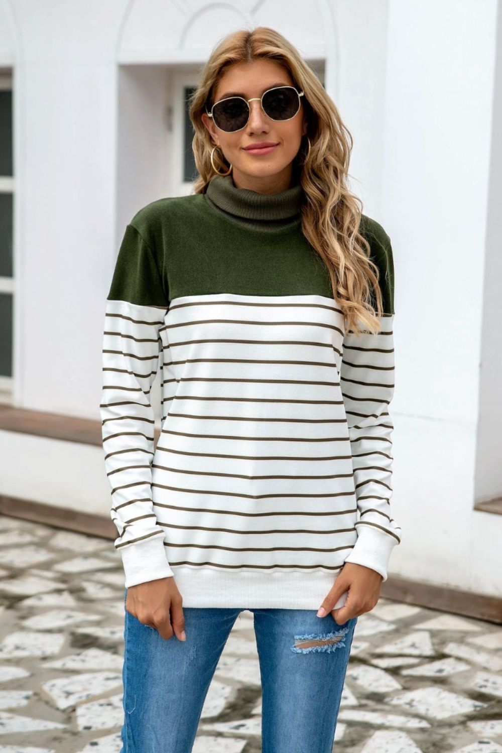 Colorblock stripe turtleneck knit sweater with army green top and white striped body.