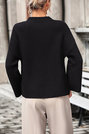 Black ribbed mock neck sweater with volume sleeves and a relaxed fit.