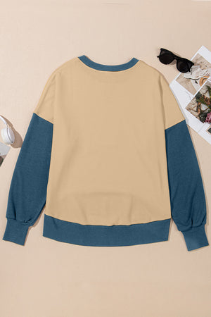 Chic Contrast Crewneck Sweatshirt in tan with blue sleeves and trim.