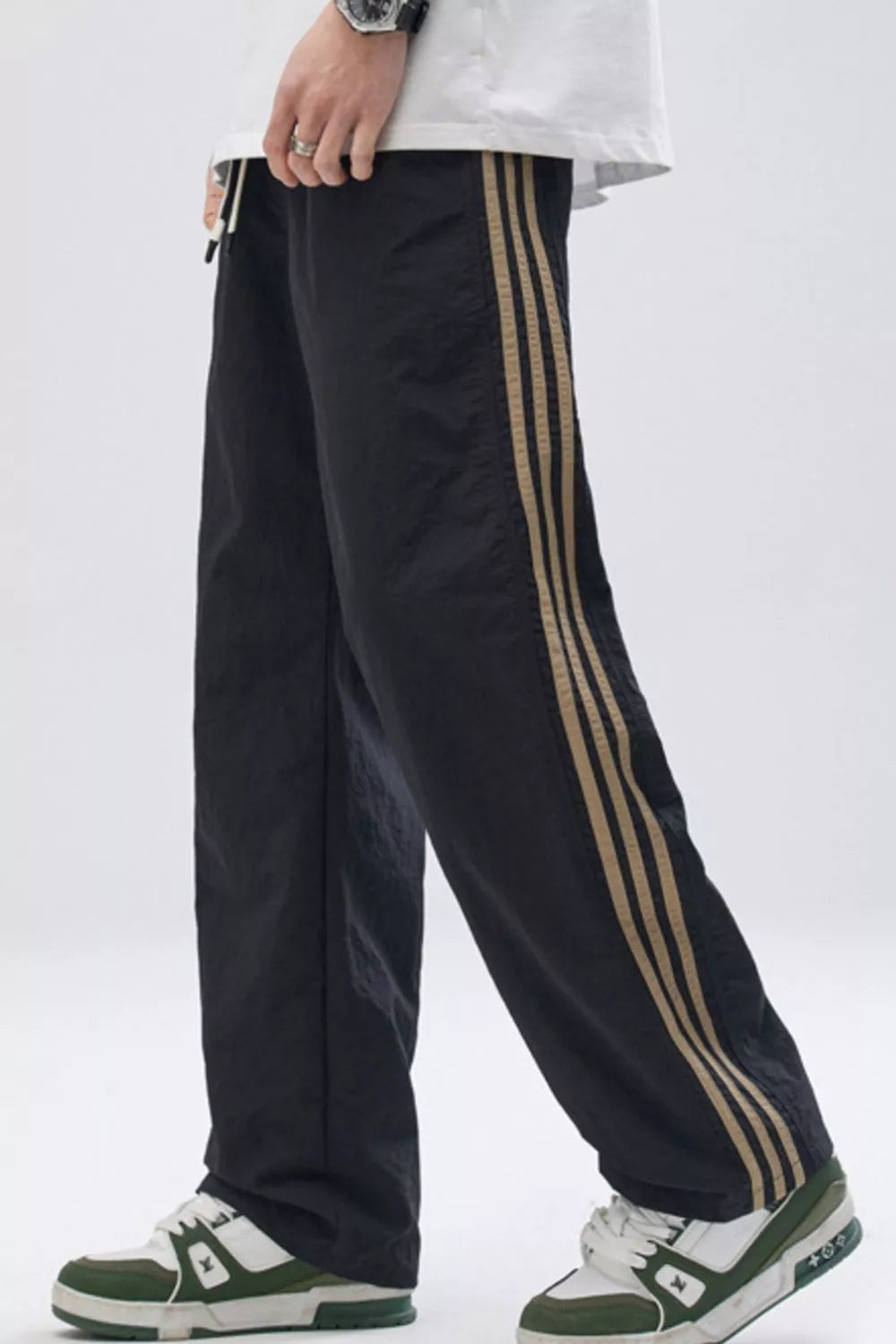 Black relaxed fit wide-leg sweatpants with tan side stripes