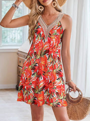 A-line dress with tropical leaf print in red and orange, featuring a crochet V-neckline.