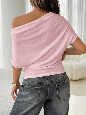 Pink ruched off-shoulder knit t-shirt with dolman sleeves.