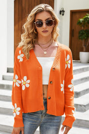 Orange knit cardigan with white daisy embroidery, button front, and V-neck.