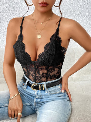 Black lace bodysuit with scalloped trim and adjustable straps, styled with jeans and a belt.
