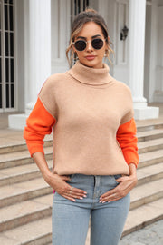 Colorblock turtleneck sweater in khaki with orange sleeves and asymmetric hem.
