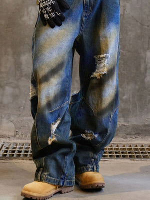 Men's blue distressed wide-leg cotton jeans with ripped details.