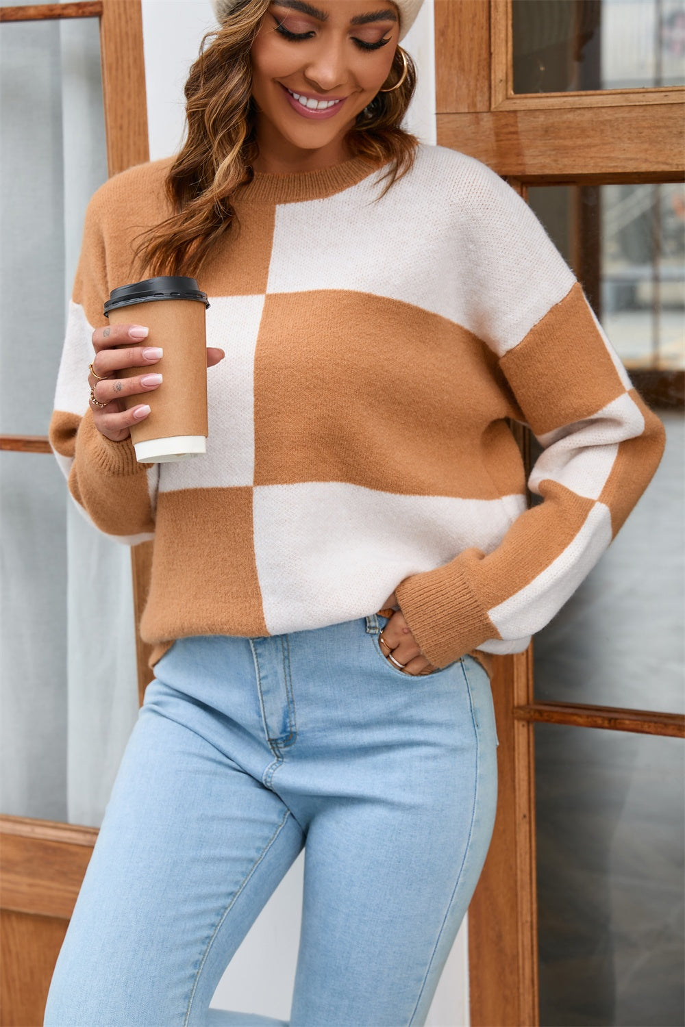 Checkerboard knit crewneck sweater in tan and white acrylic with a casual fit.