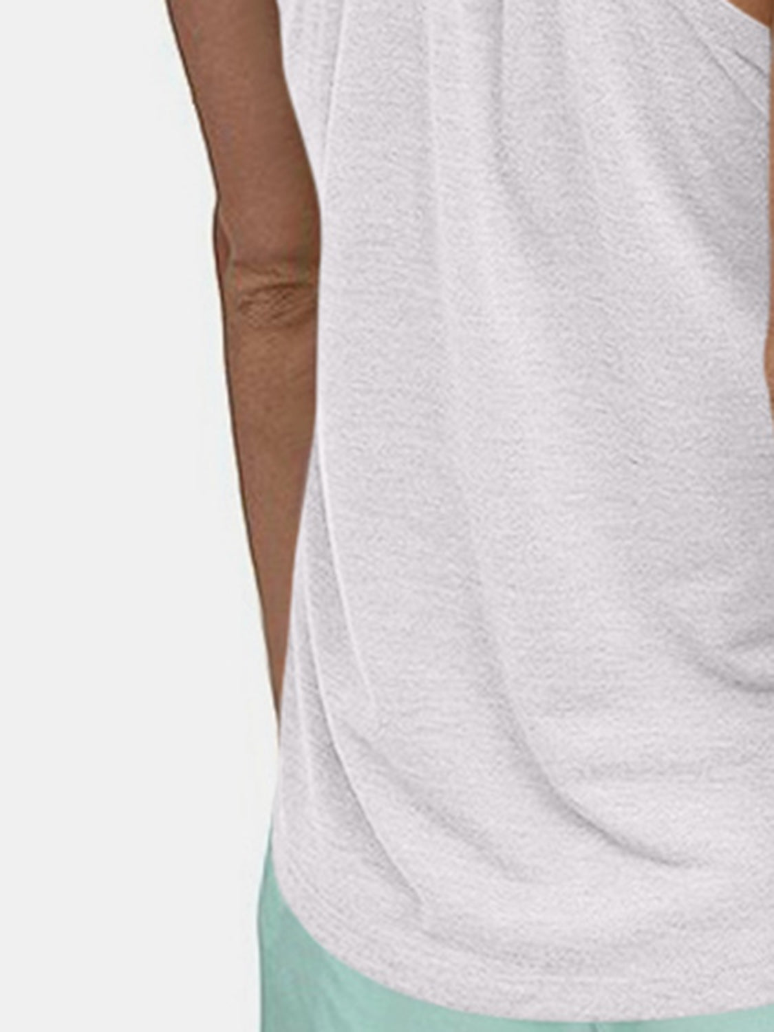 White racerback performance tank top with a textured fabric detail.