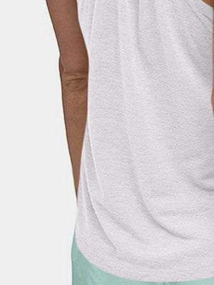 White racerback performance tank top with a textured fabric detail.