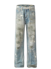 Distressed wash wide leg denim jeans in medium blue with paint splatters and fading.