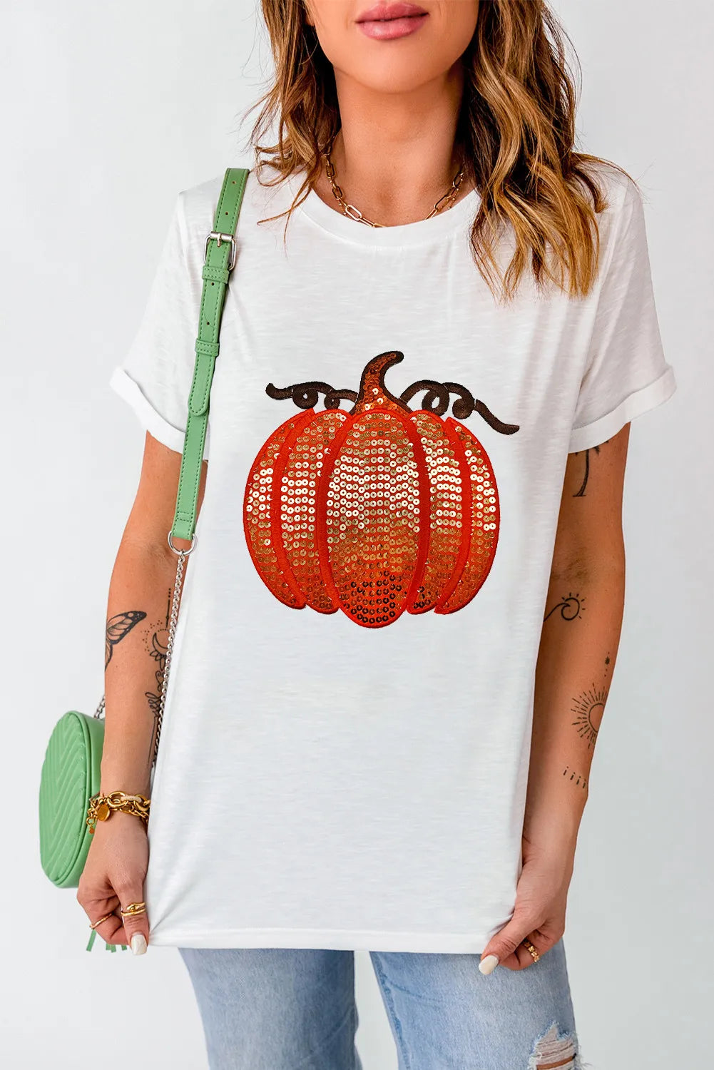 White tee with sequin pumpkin appliqué and rolled sleeves.