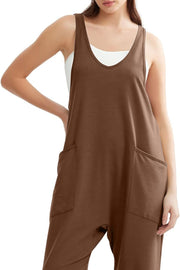 Brown relaxed fit pocketed jumpsuit with V-neck and tank straps, layered over white cami.