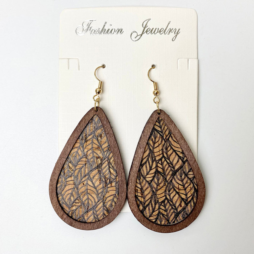 Cork teardrop earrings with botanical leaf print and wooden frame.