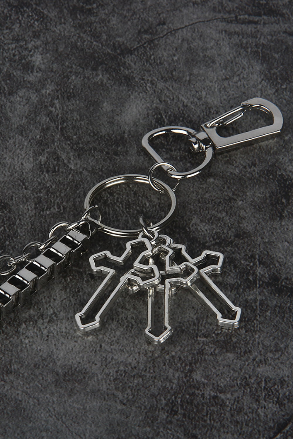 Silver geometric chain waist accessory with three crossed cross charms and a lobster clasp.