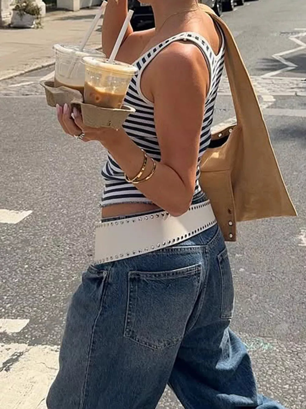 Ribbed striped scoop neck tank top with a cropped fit, worn by a woman holding coffee cups.