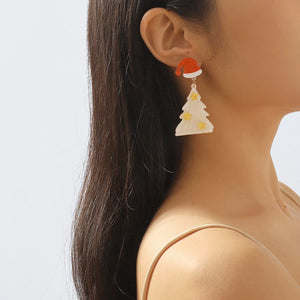 White festive holiday tree dangle earrings with gold stars and Santa hat detail