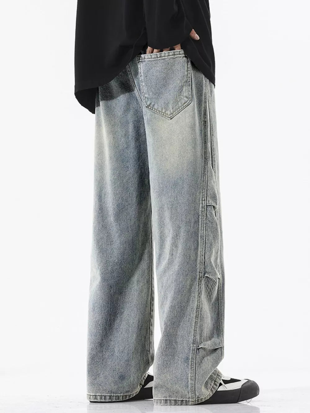 Light wash oversized wide leg jeans with distressed details and vintage fade.