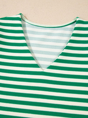 Green and white striped V-neck sweater with textured fabric detail.