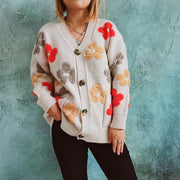 Ivory embroidered floral knit cardigan with button front and V-neck.