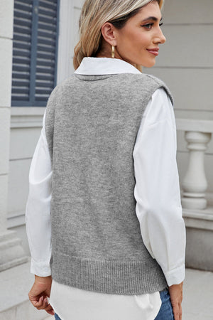Gray acrylic knit vest with button front and shoulder detail, worn over a white shirt.