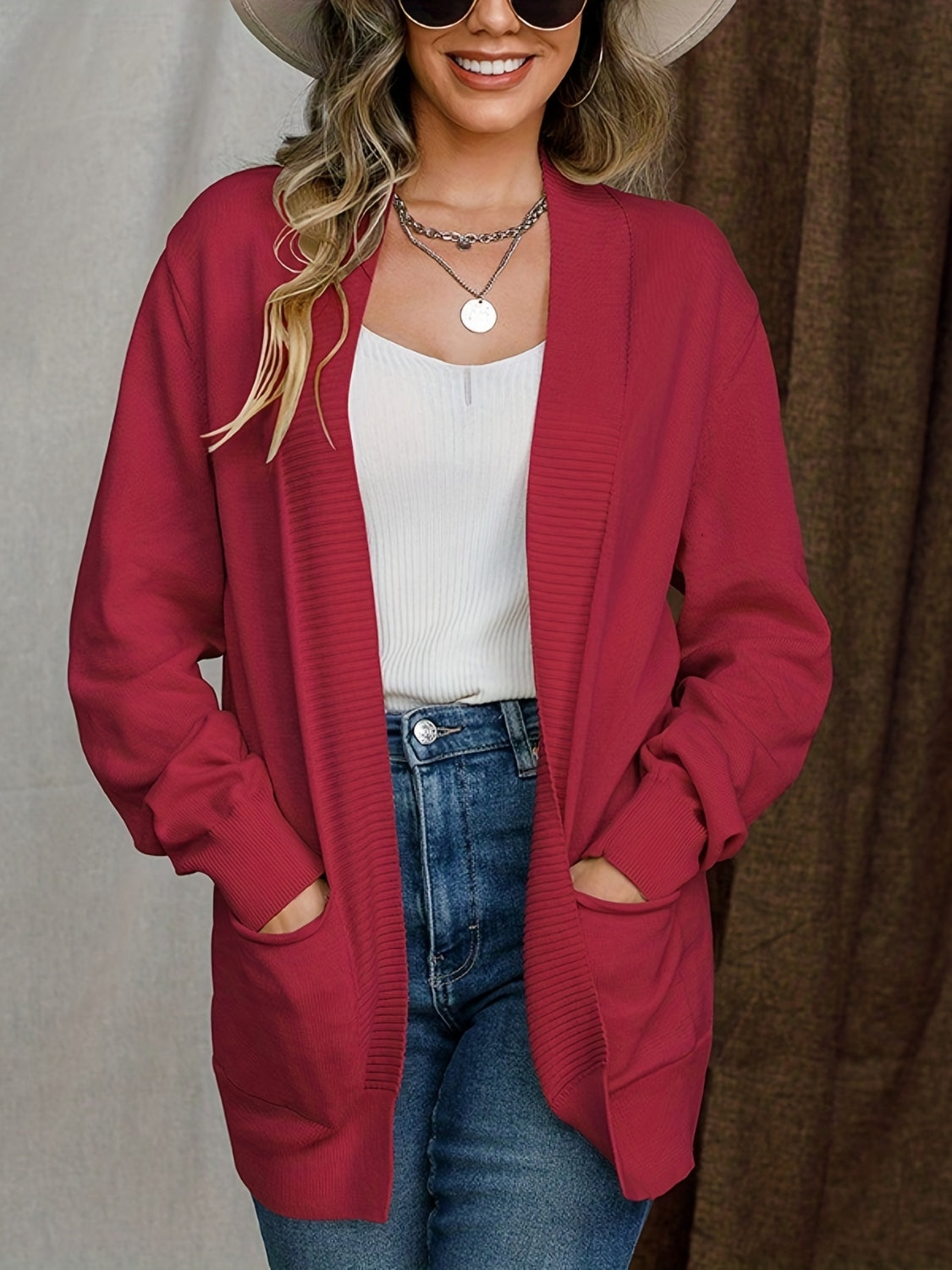 Deep red textured knit open-front cardigan with pockets and ribbed cuffs.
