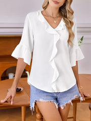 White maternity shirt with cascading ruffles, V-neck, and 3/4 bell sleeves.