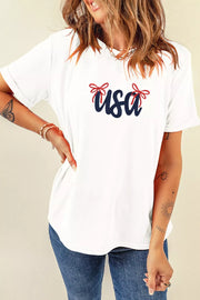 White cotton t-shirt with embroidered navy USA text and red bows.