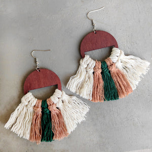 Geometric macrame tassel earrings with wood semicircle top in white, green, and brown.