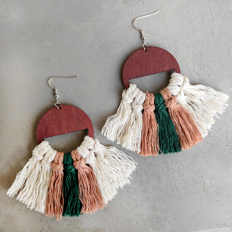 Geometric macrame tassel earrings with wood semicircle top in white, green, and brown.