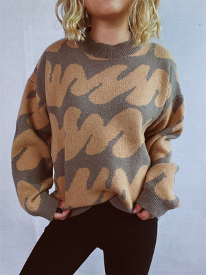 Graphic Wave Knit Sweater in camel and brown with a crew neck and long sleeves.