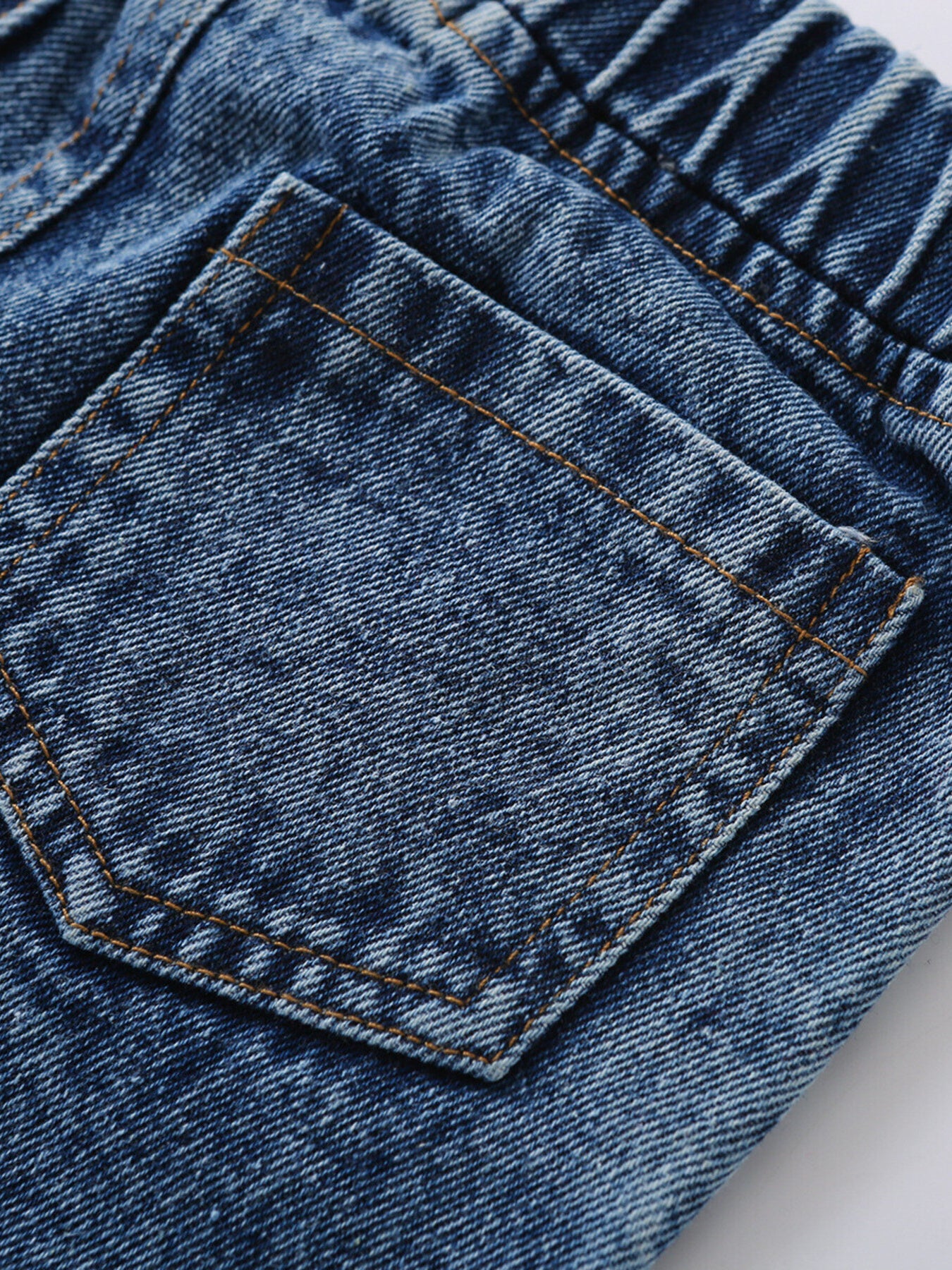 Toddler blue denim jeans with elastic waistband and back pocket detail.