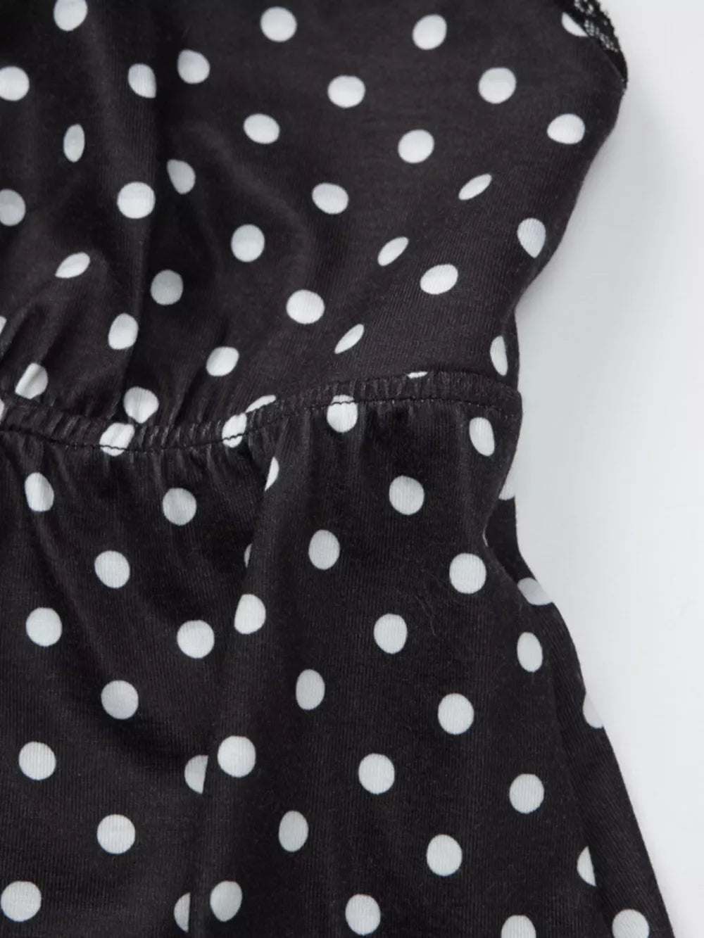 Black polka dot cami with white dots and lace trim detail.
