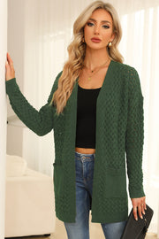 Dark green open-knit pocket cardigan with textured pattern and long sleeves.