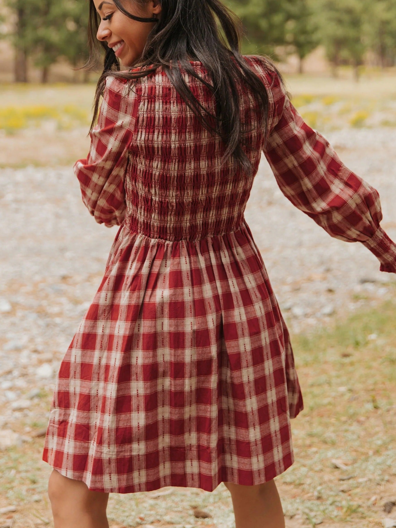 Red plaid cotton mini dress with smocked bodice and puff sleeves.