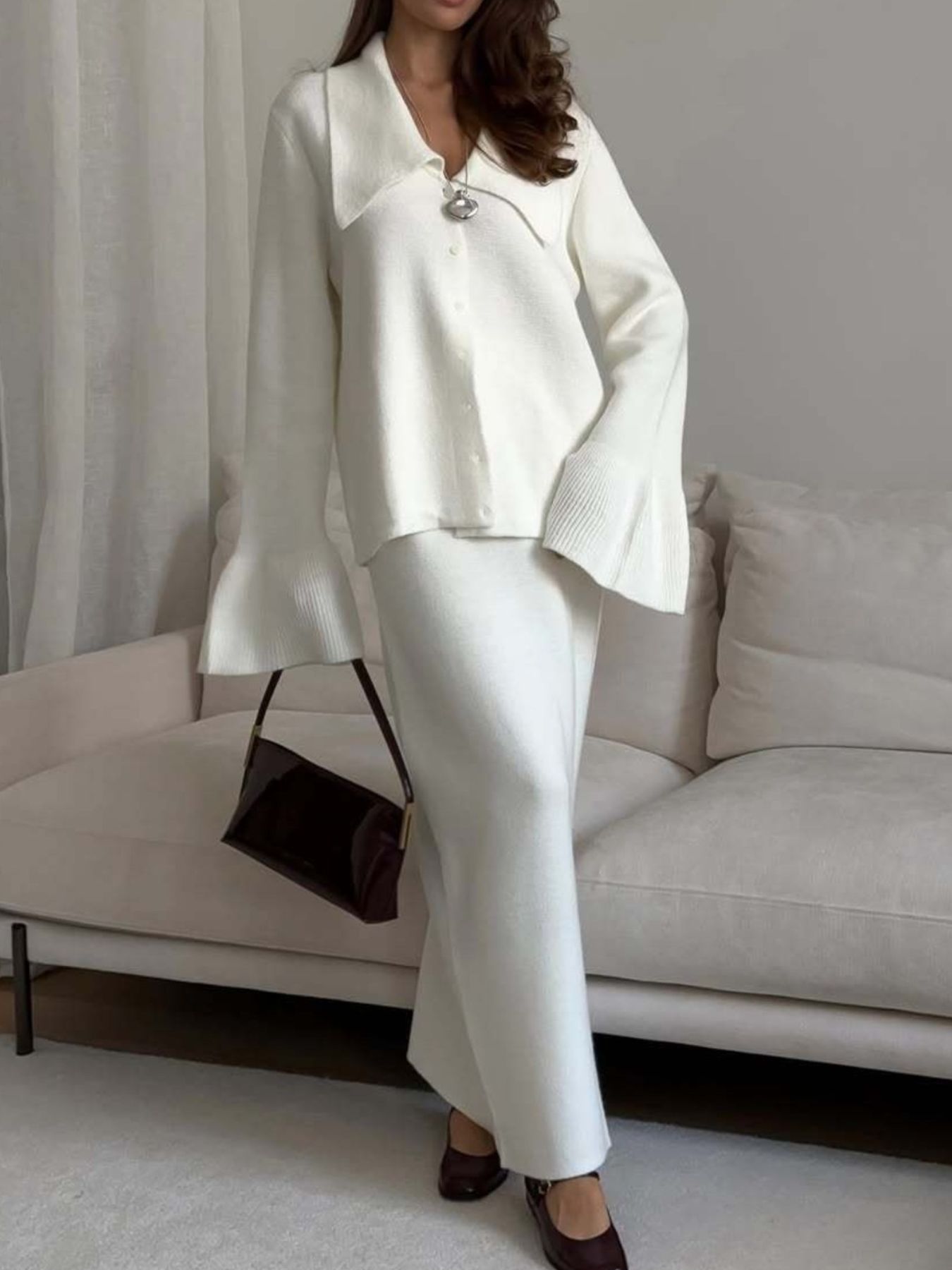 Milky white ribbed knit cardigan with collar and flared sleeves, paired with a matching knit skirt.