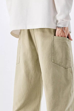 Men's relaxed fit cotton jeans in sage with drawstring waist and patch pockets.