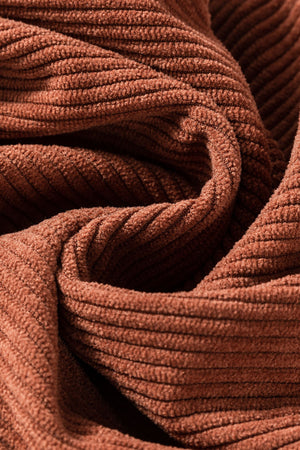 Brown corduroy flared leg trousers, showing ribbed texture and fabric detail.