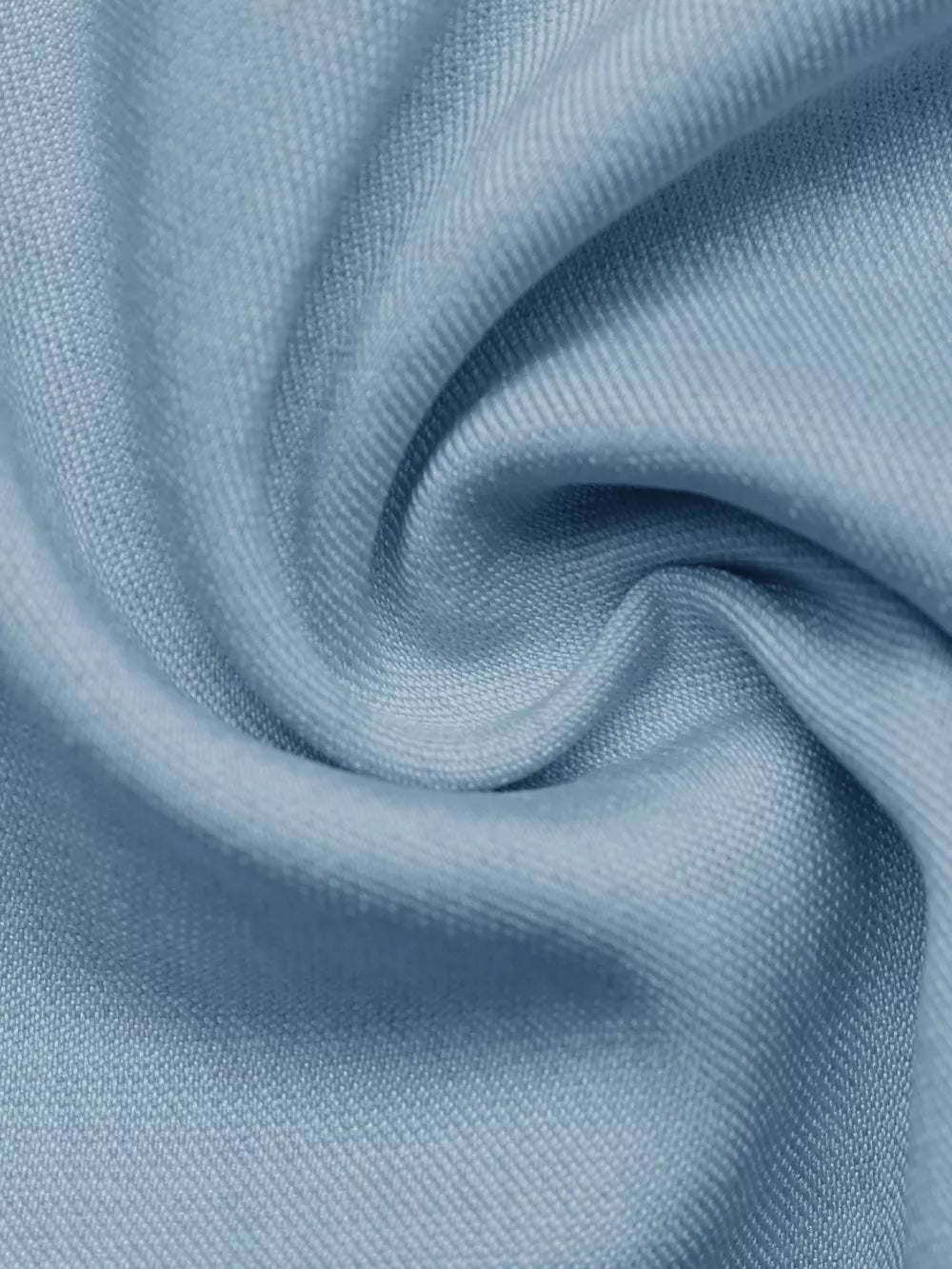 Light blue fabric detail of a buttoned vest and tailored shorts set.