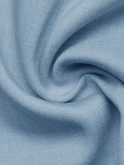 Light blue fabric detail of a buttoned vest and tailored shorts set.